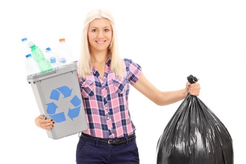 Driver securing a covered skip on a waste collection vehicle
